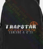 Black Trapstar Body Bag featuring signature logo branding, adjustable shoulder strap, secure zip compartments, and a compact streetwear design.